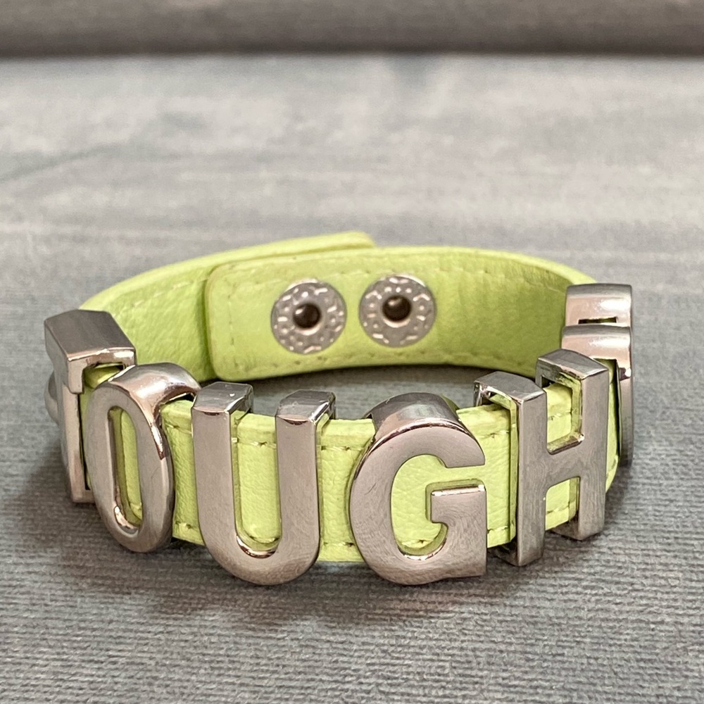 TOUGH bracelet in large silver letters with hearts and studs on mint green strap